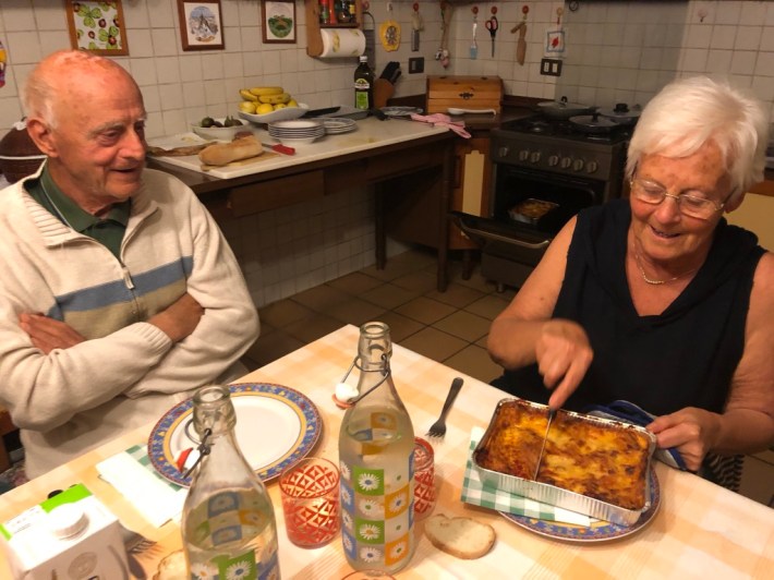 Nonna cutting her famous Semplici lasagna with Nonno.