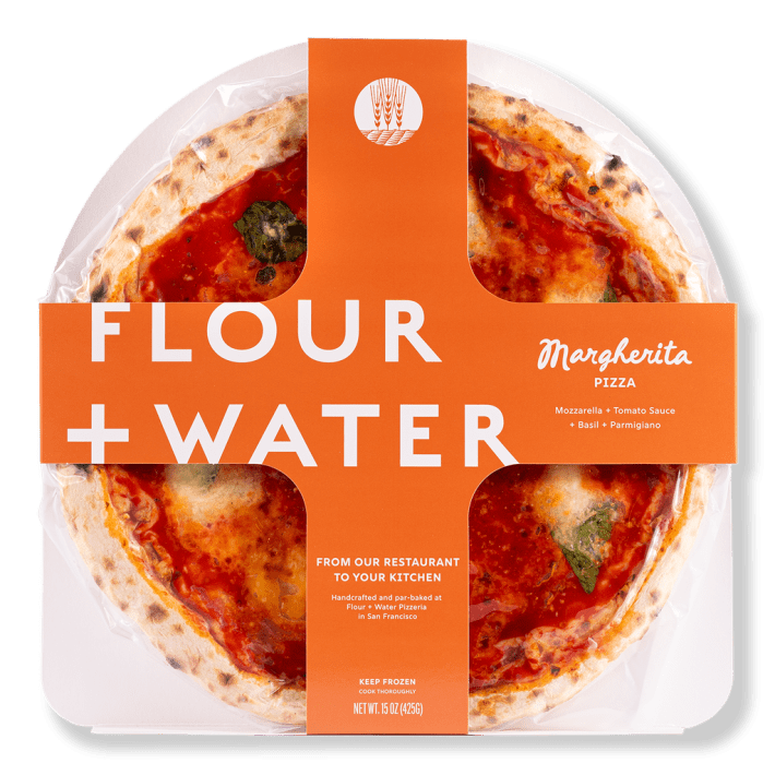 Pepperoni pizza from Flour + Water Pizzeria, now available in frozen form and packaged with the orange logo.