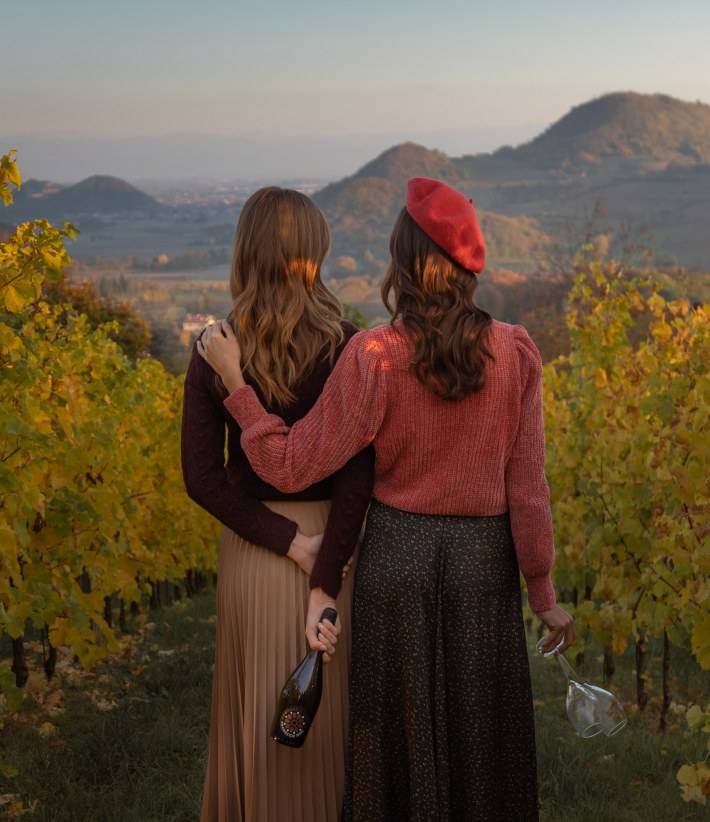 two women with prosecco overlooking scenic view