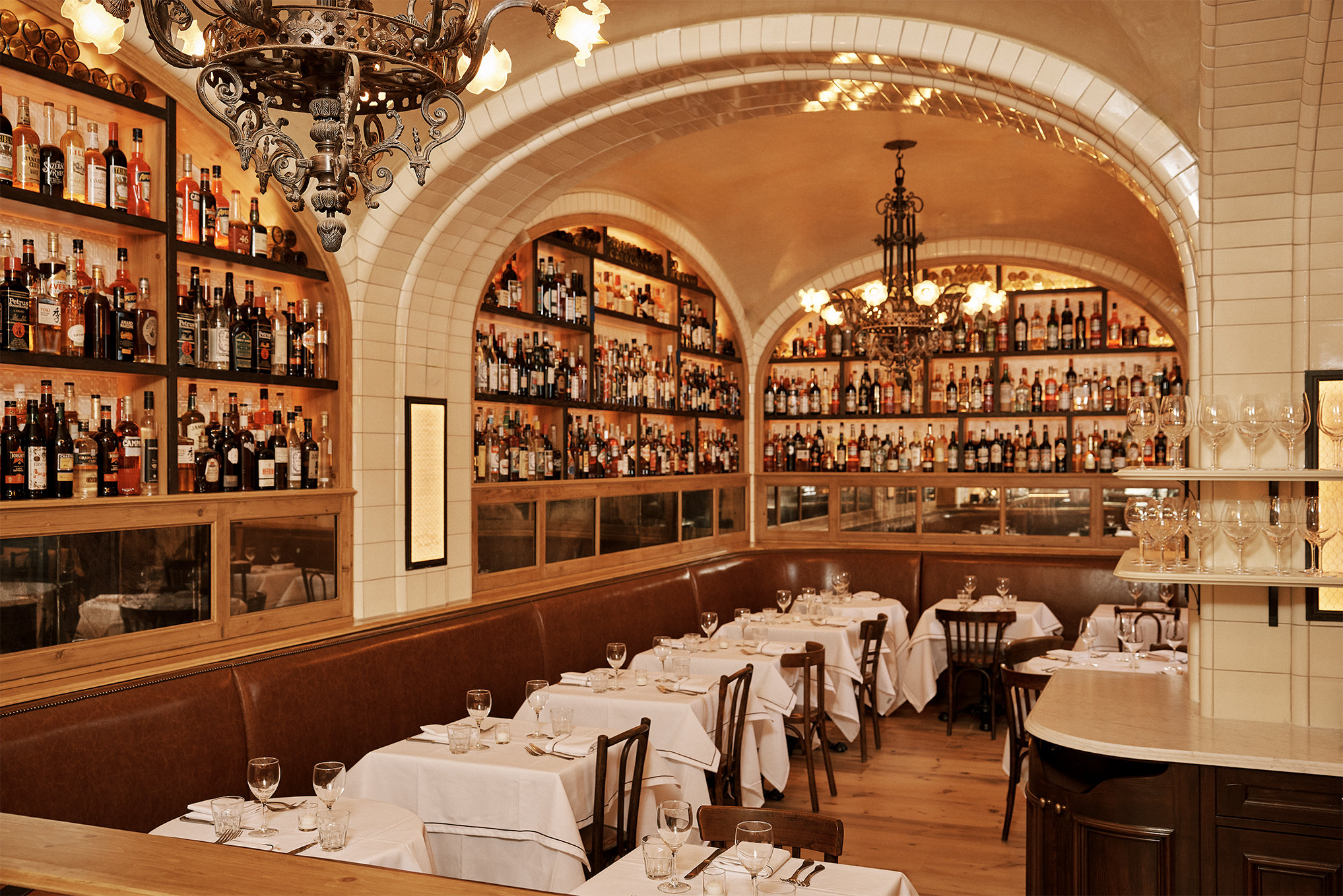 nterior of Borromini restaurant showing arched ceilings, chandeliers, and walls lined with bottles.