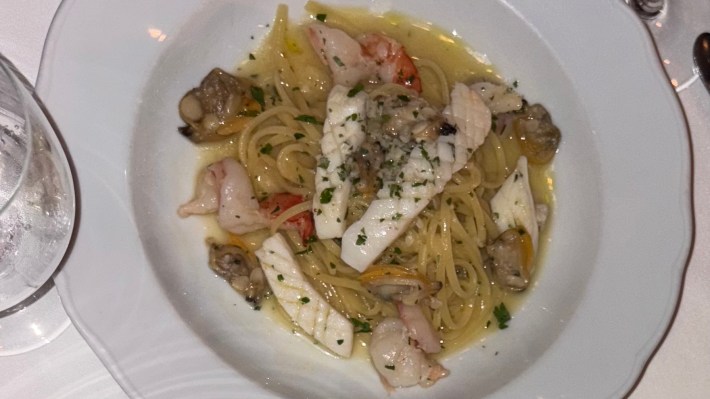 Plate of linguine with prawns, clams, and squid served in white wine sauce at CinCin Vancouver.