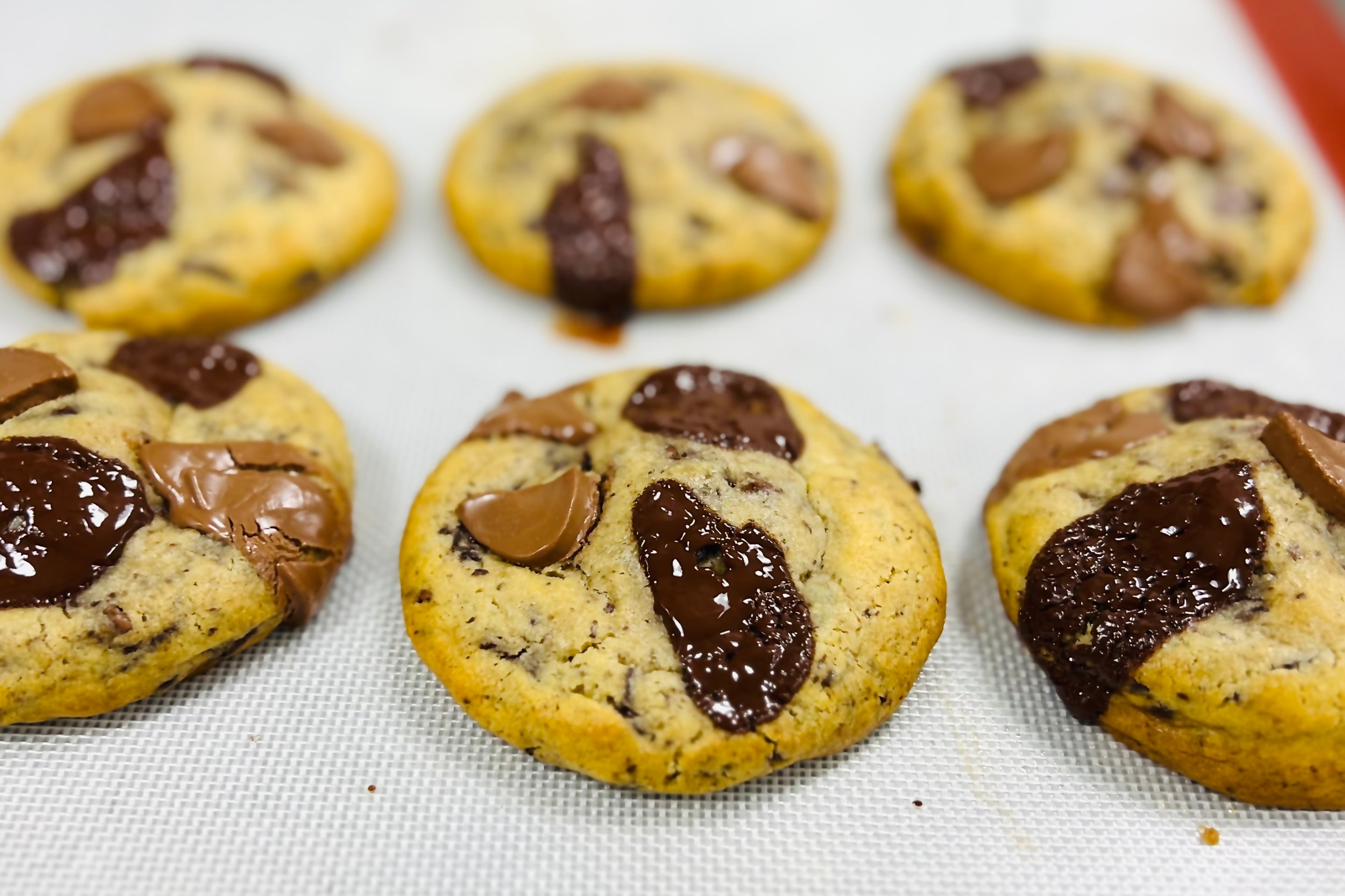 Nutella chocolate chip cookies with gooey center on parchment