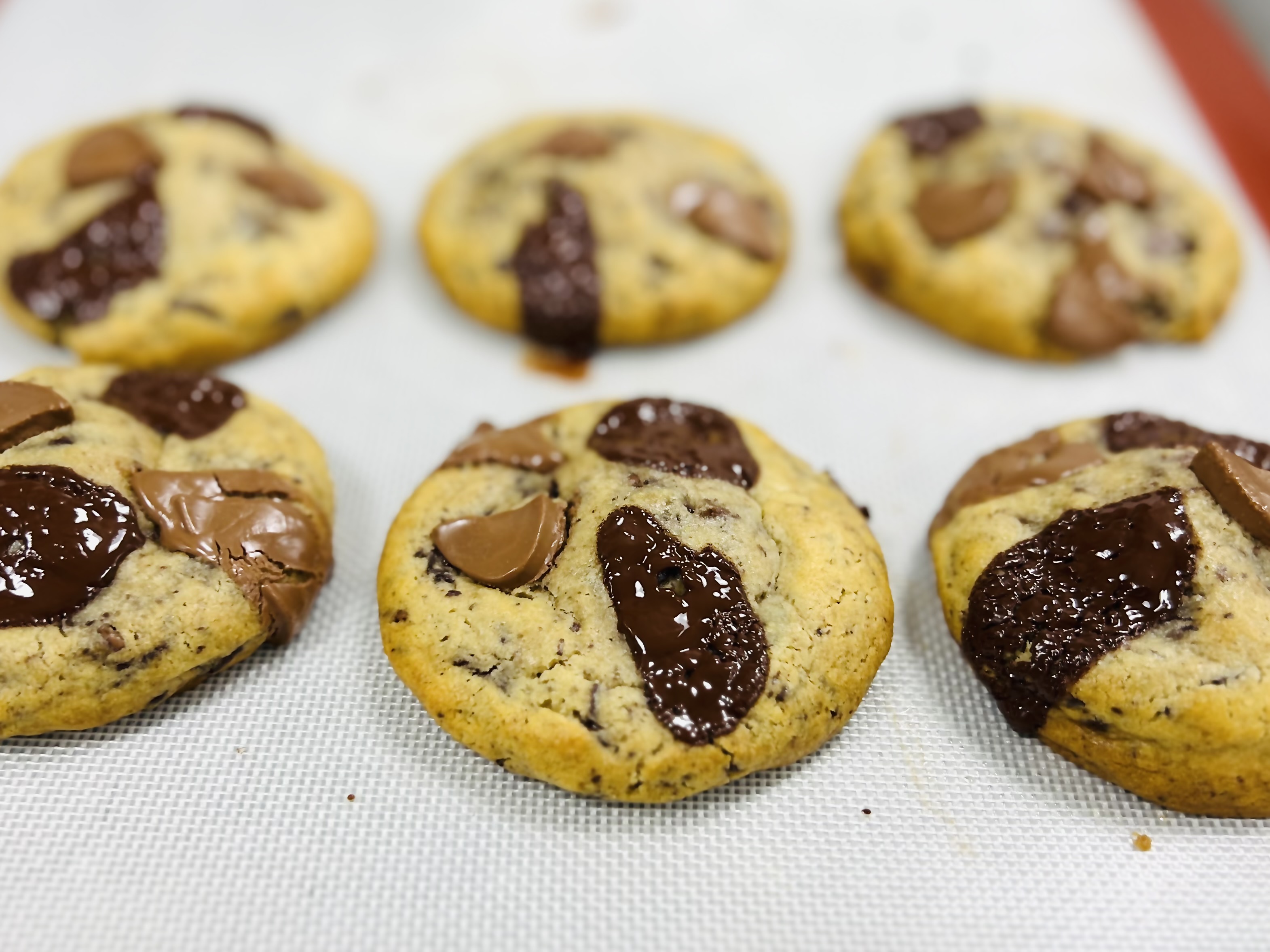 Nutella chocolate chip cookies with gooey center on parchment