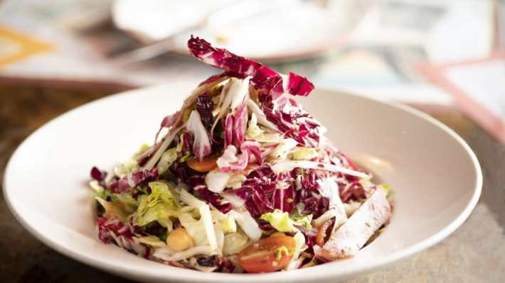 Chopped salad with radicchio, lettuce, chickpeas, and cherry tomatoes served at Osteria Mozza Lanai.