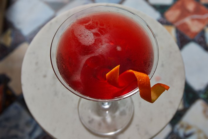 Red cocktail garnished with an orange twist at Caffè Florian in Venice.