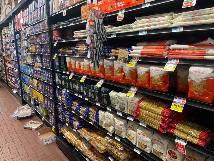 A typical supermarket row lined with pastas at various price points.