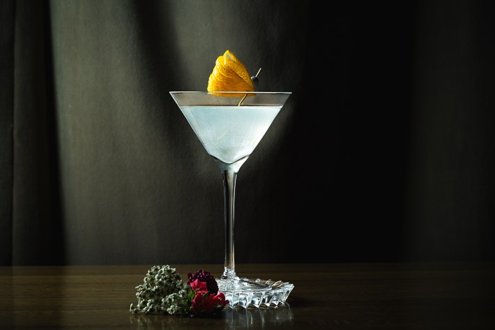 Clear cocktail in a stemmed glass garnished with citrus peel at Dēliz in Bucktown.