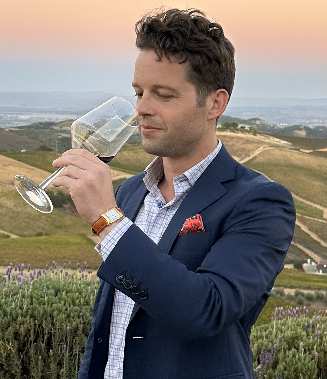 Writer Johnny Motley enjoying a glass of red wine in the Sicilian countryside.
