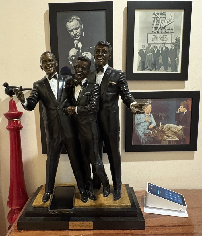 Rat Pack statue displayed inside Patsy’s Italian Restaurant with vintage photos.