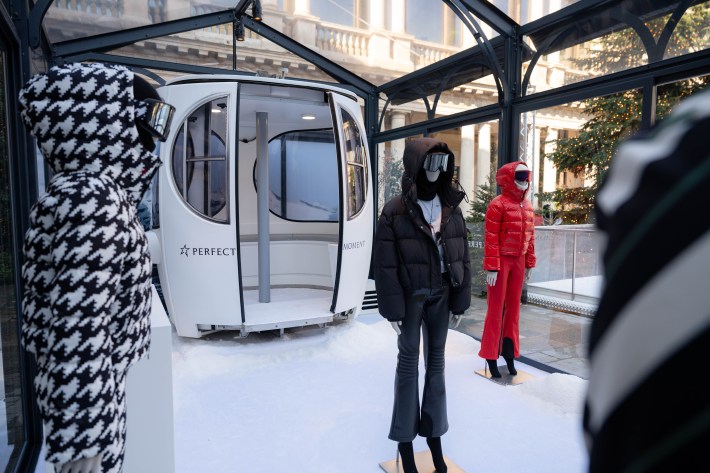 Winter fashion display inside glass greenhouse at Portrait Milano ice skating rink.