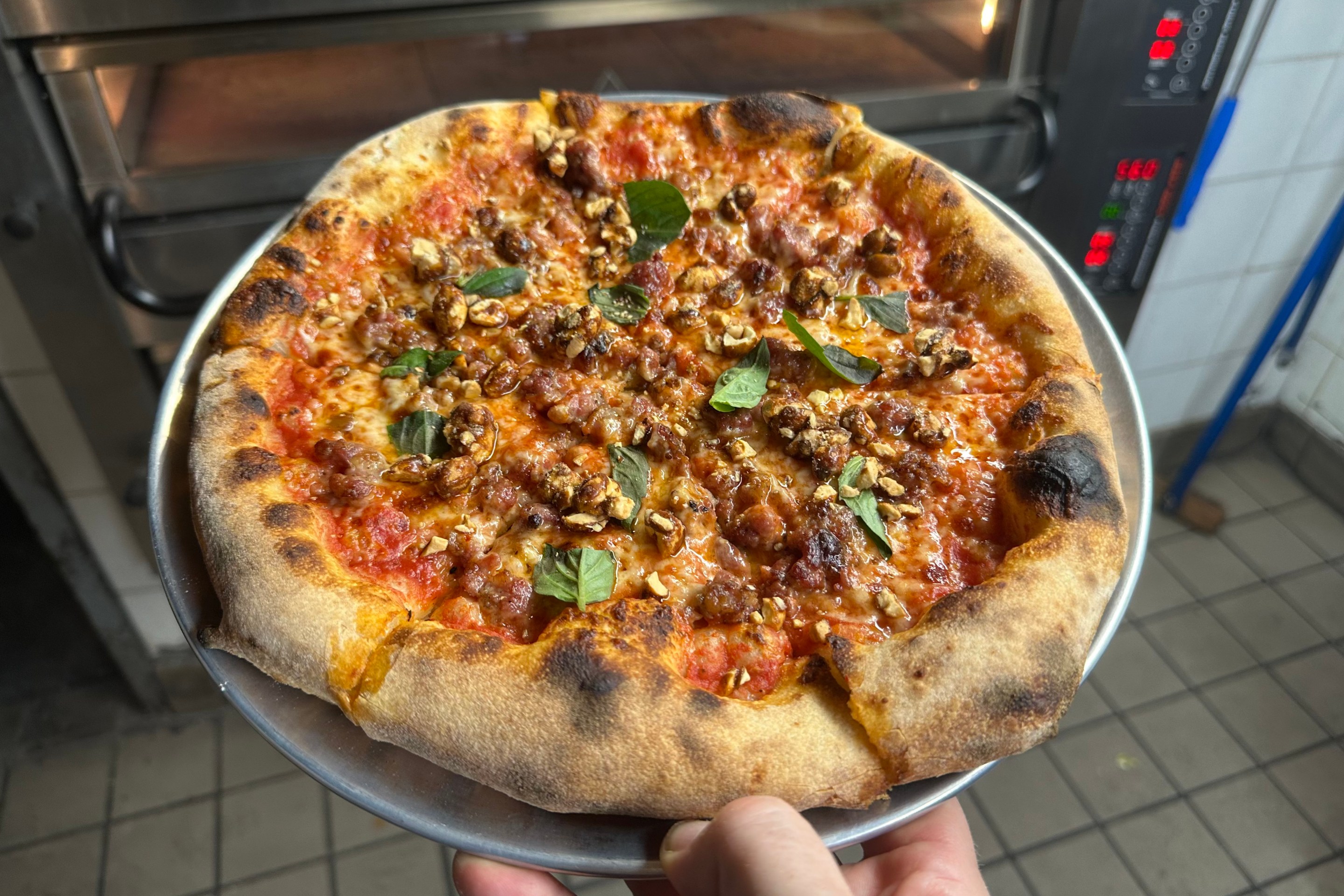 Ops x Momofuku Noodle Bar: Spicy pork sausage pie with chili oil, caramelized peanuts, tomato sauce, and basil.