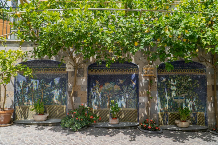 Lemon trees and hand-crafted mosaics inside the gardens of Grand Hotel La Favorita. Photo by Favorita Hotel.
