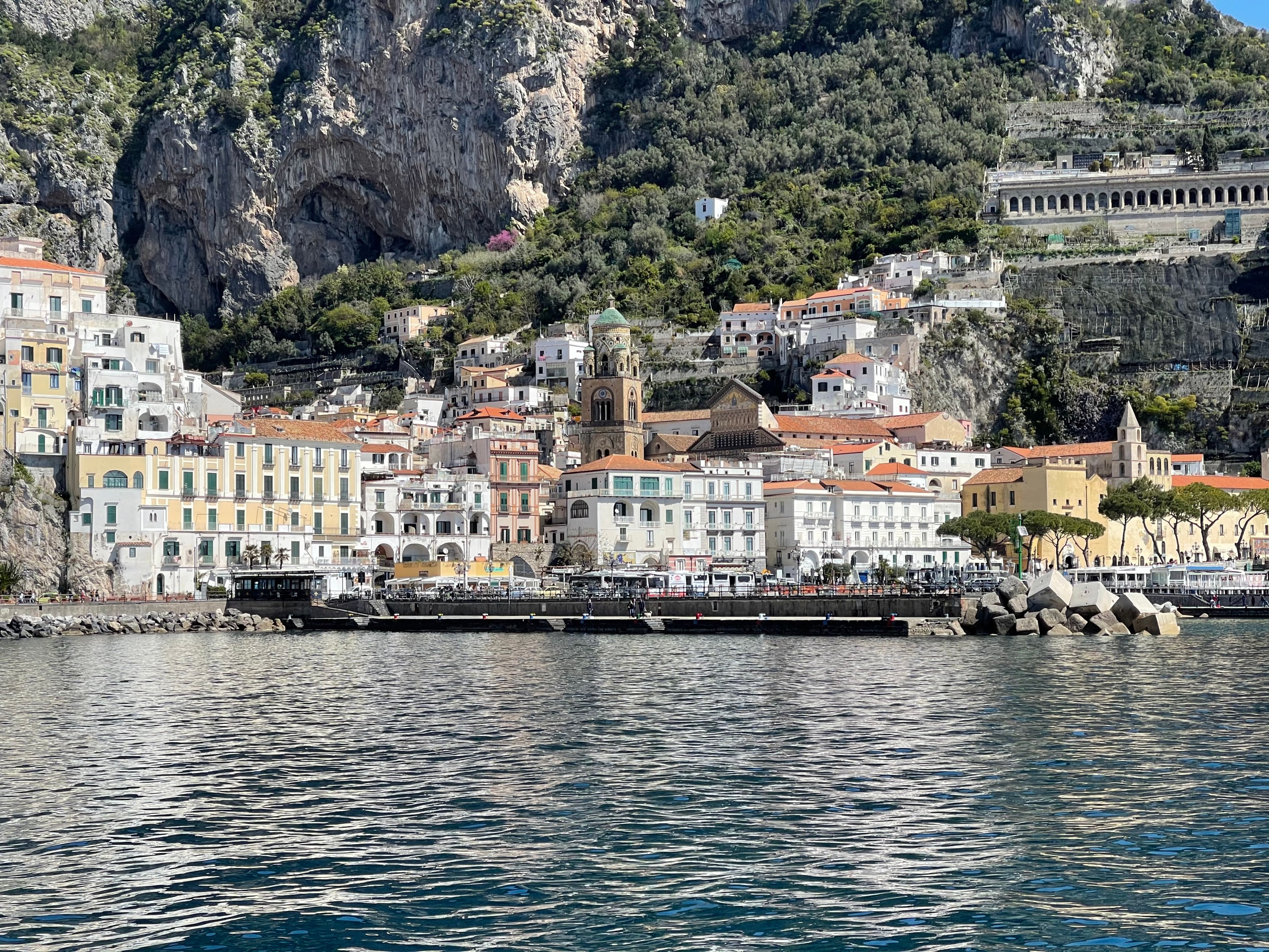 Panoramic view of the Amalfi coastline and historic town overlooking the sea.
