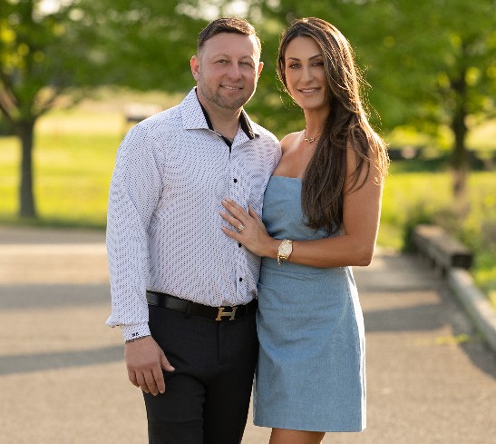 Matthew Borowski and Liz Borowski namesake of Elizabeth’s Italian restaurant, standing together with trees in background.