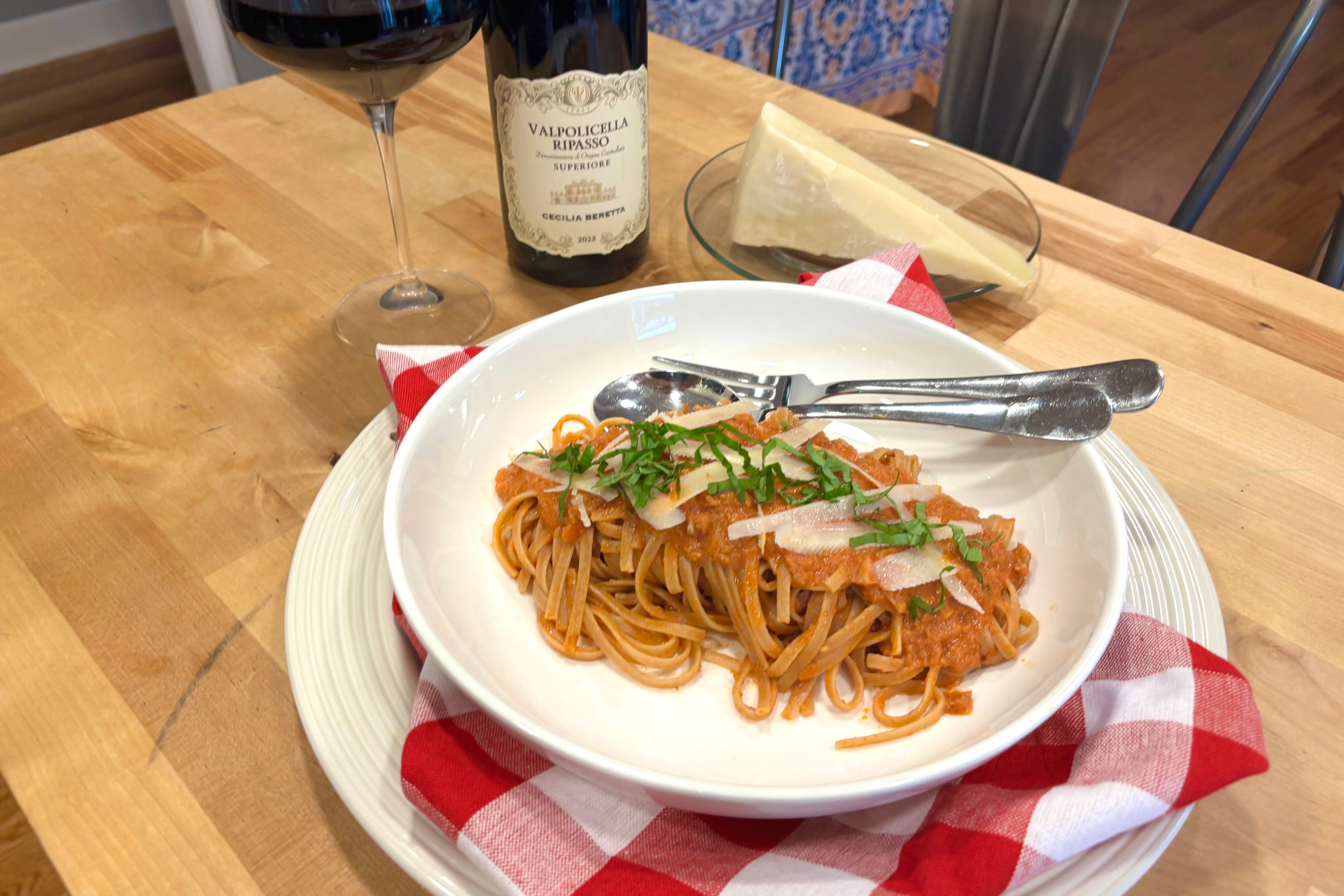 Turkey bolognese served over pasta with basil and shaved pecorino cheese