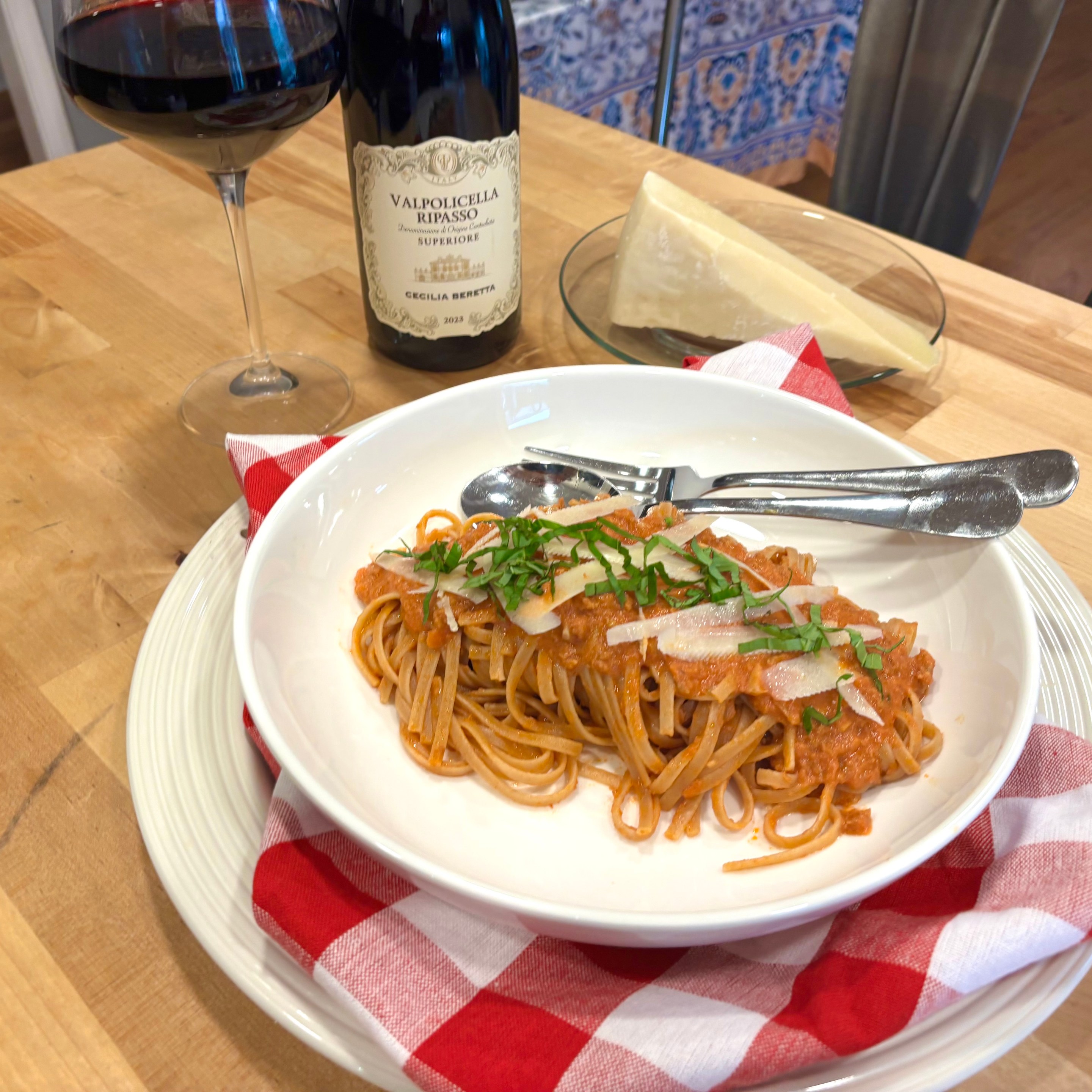 Turkey bolognese served over pasta with basil and shaved pecorino cheese