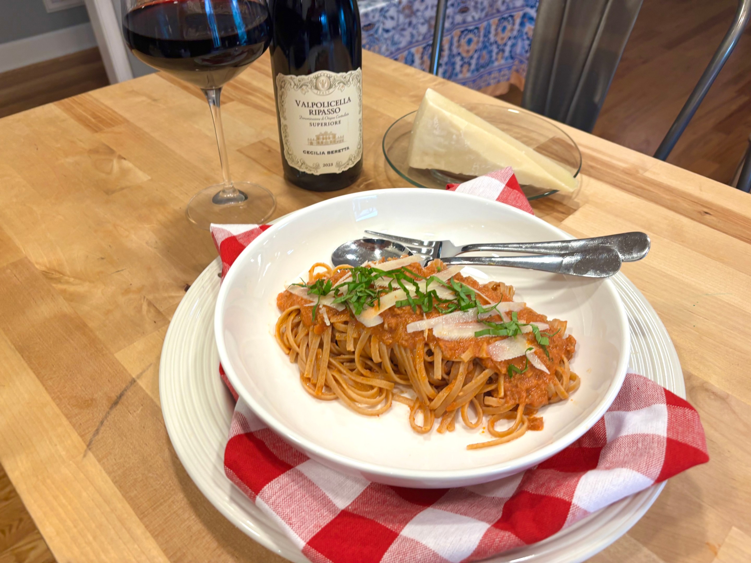 Turkey bolognese served over pasta with basil and shaved pecorino cheese