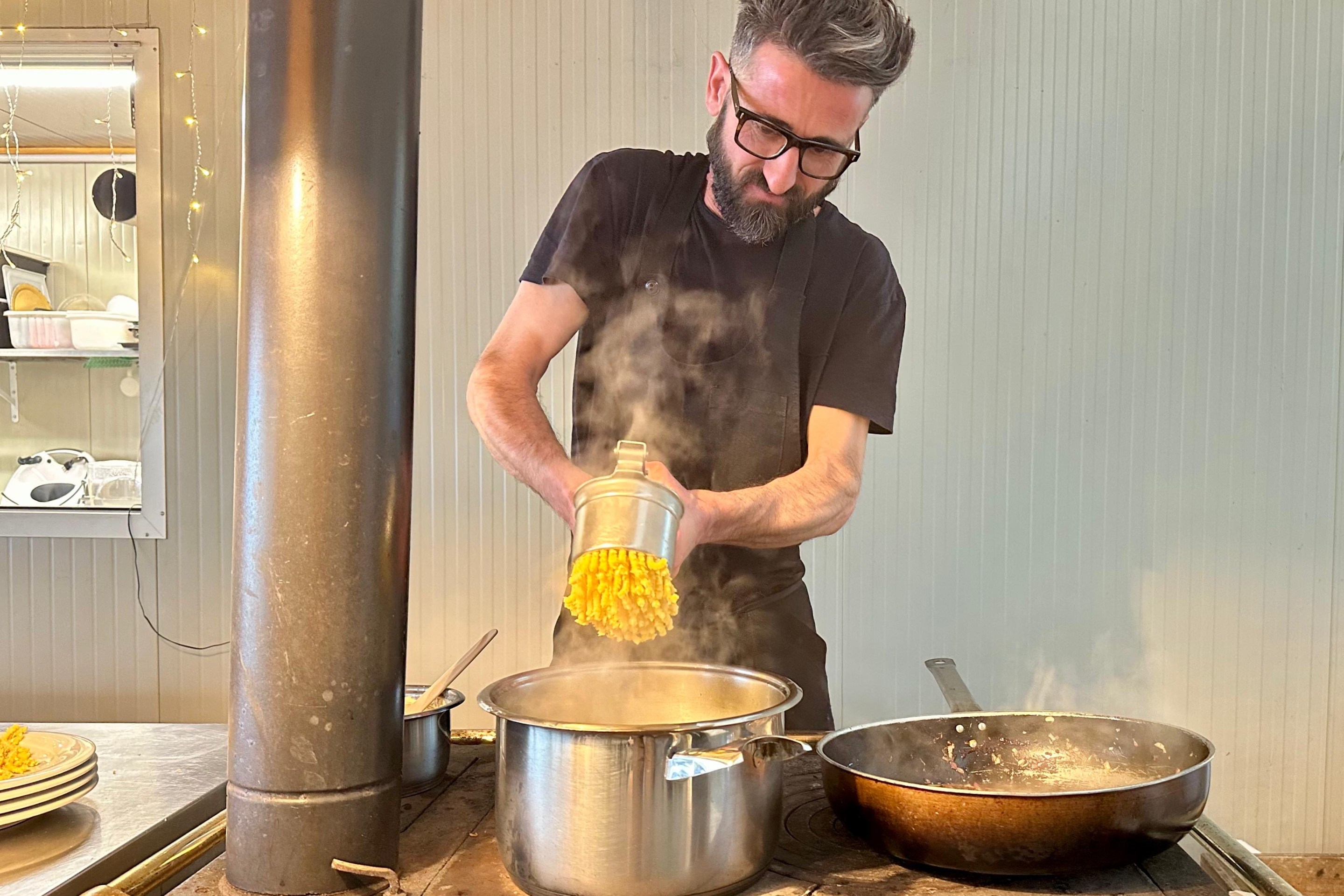 Chef Riccardo Severi making fresh passatelli by hand in his kitchen. Photo credit Marco Valgiusti
