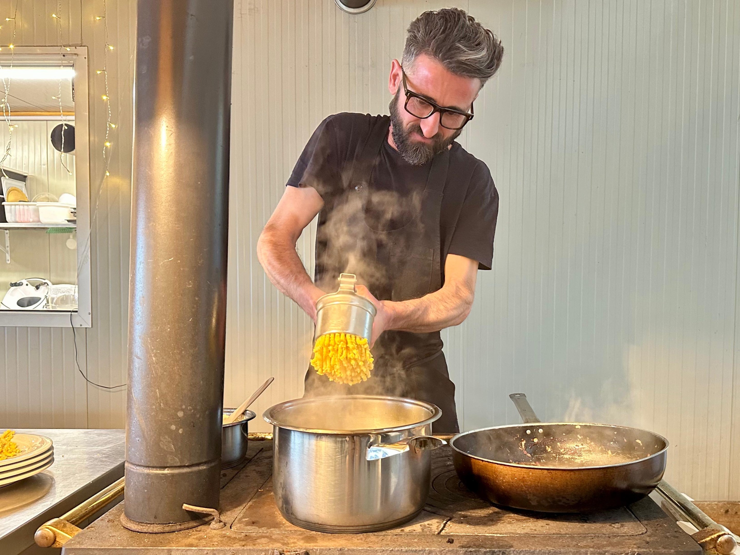 Chef Riccardo Severi making fresh passatelli by hand in his kitchen. Photo credit Marco Valgiusti