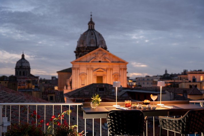 The hotel’s rooftop terrace offers the perfect spot for an aperitivo or dinner as the sun sets over the Eternal City. Photo courtesy of Palazzo Navona.