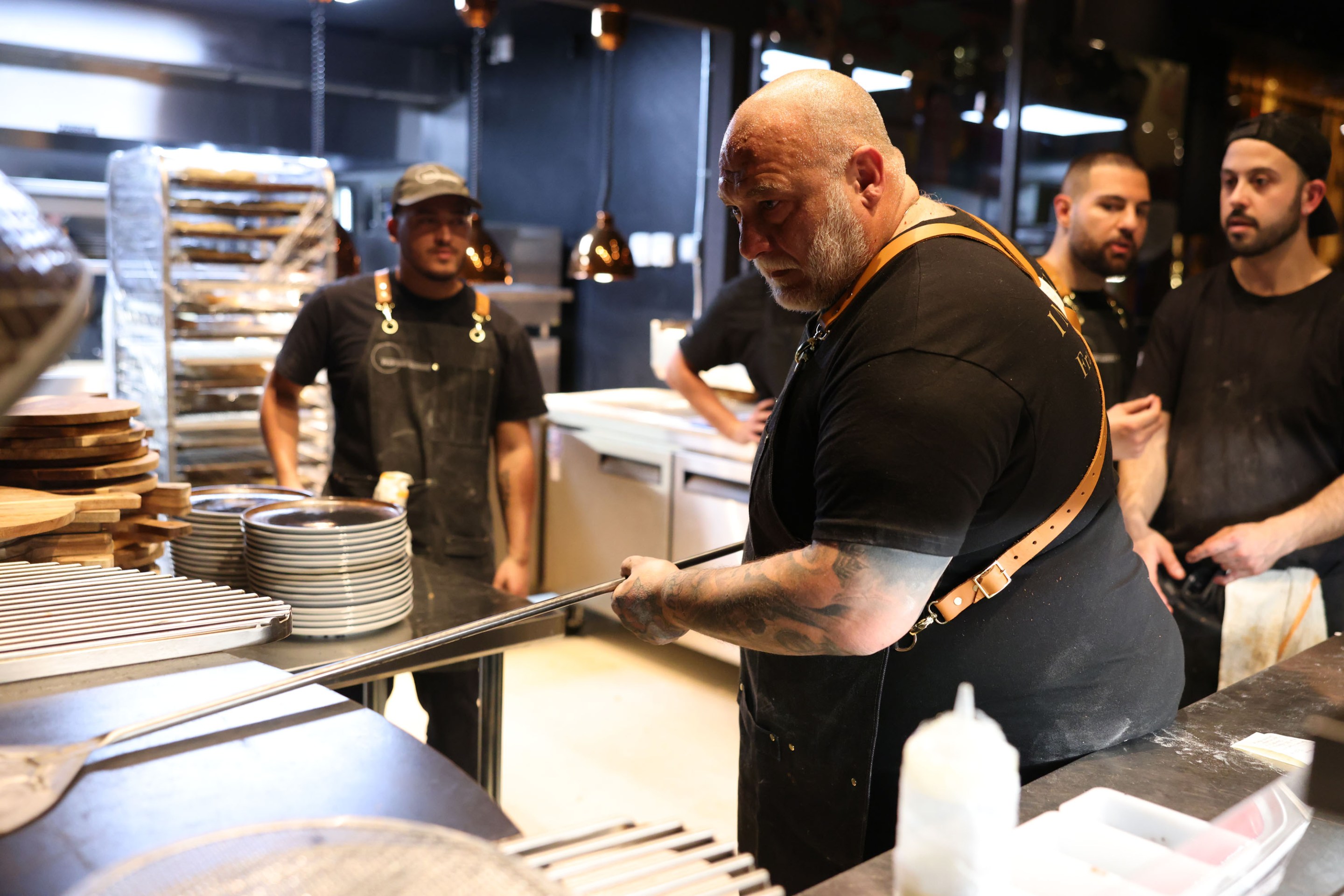 Francesco Martucci preparing pizza in the kitchen at his Miami restaurant.