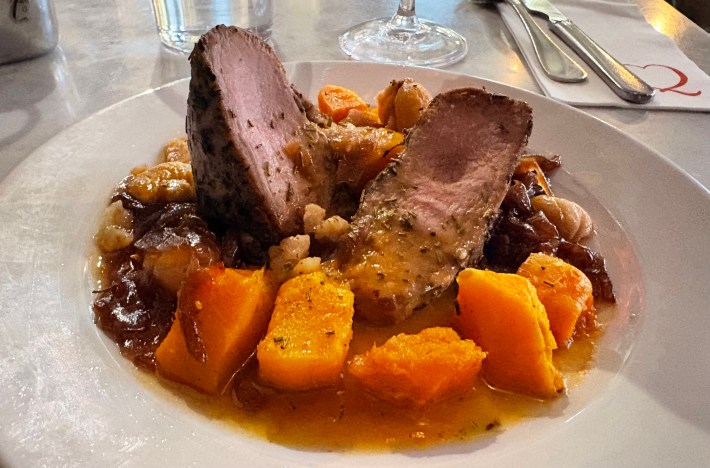 Pork loin with pumpkin and chestnuts at restaurant in Milan