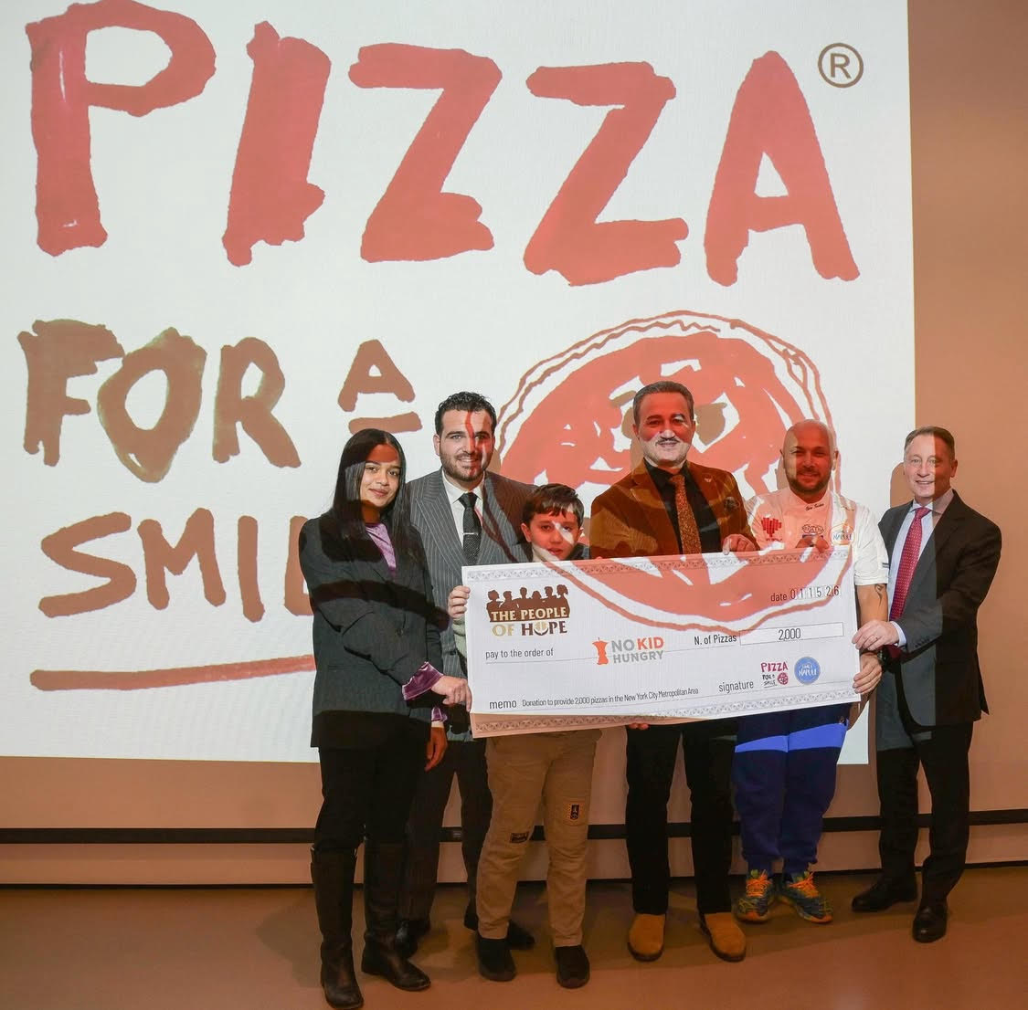 The official donation of 2,000 pizzas at the "Pizza for a Smile" celebration at the Italian American Museum in New York City. Pictured, from left to right: Nyah Estevez, No Kid Hungry; entertainer Sal "The Voice" Valentinetti; Sebastion Lamonarca; Luciano Lamonarca; Ciro Iovine , Song' E Napule; TV anchor Rob Astorino.
