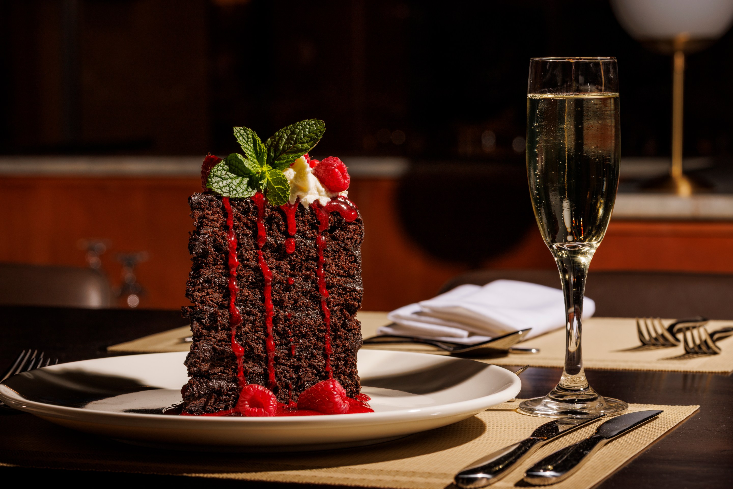 Chocolate cake topped with cream, raspberries and mint at Urban Italia in Dallas.