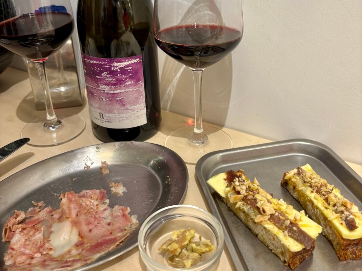 Natural red wine with small plates of anchovies, butter, and bread at Barro Rome