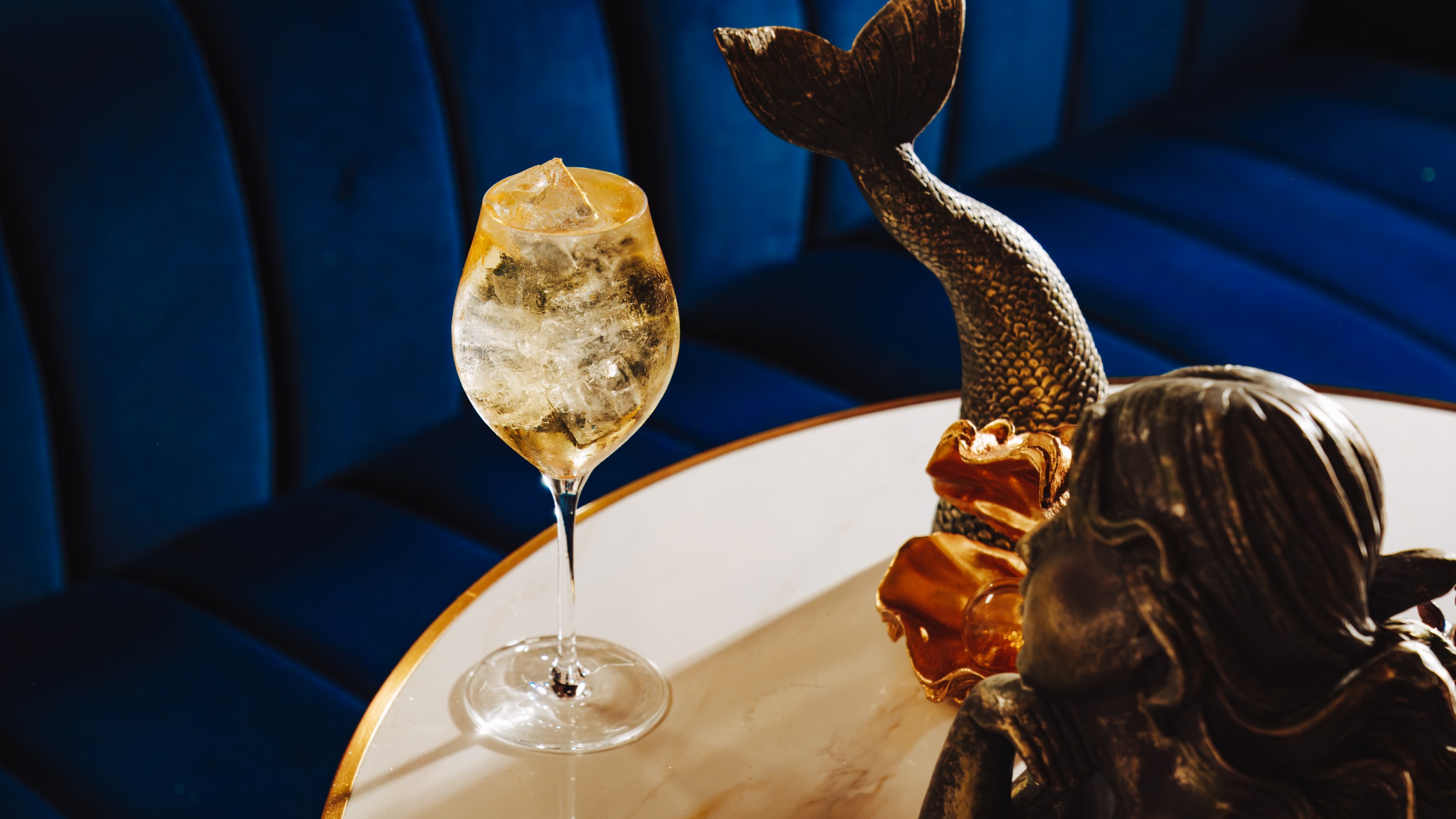 The Seirēn Song Spritz, a gold-infused cocktail inspired by the aperitif traditions of Portugal and Spain