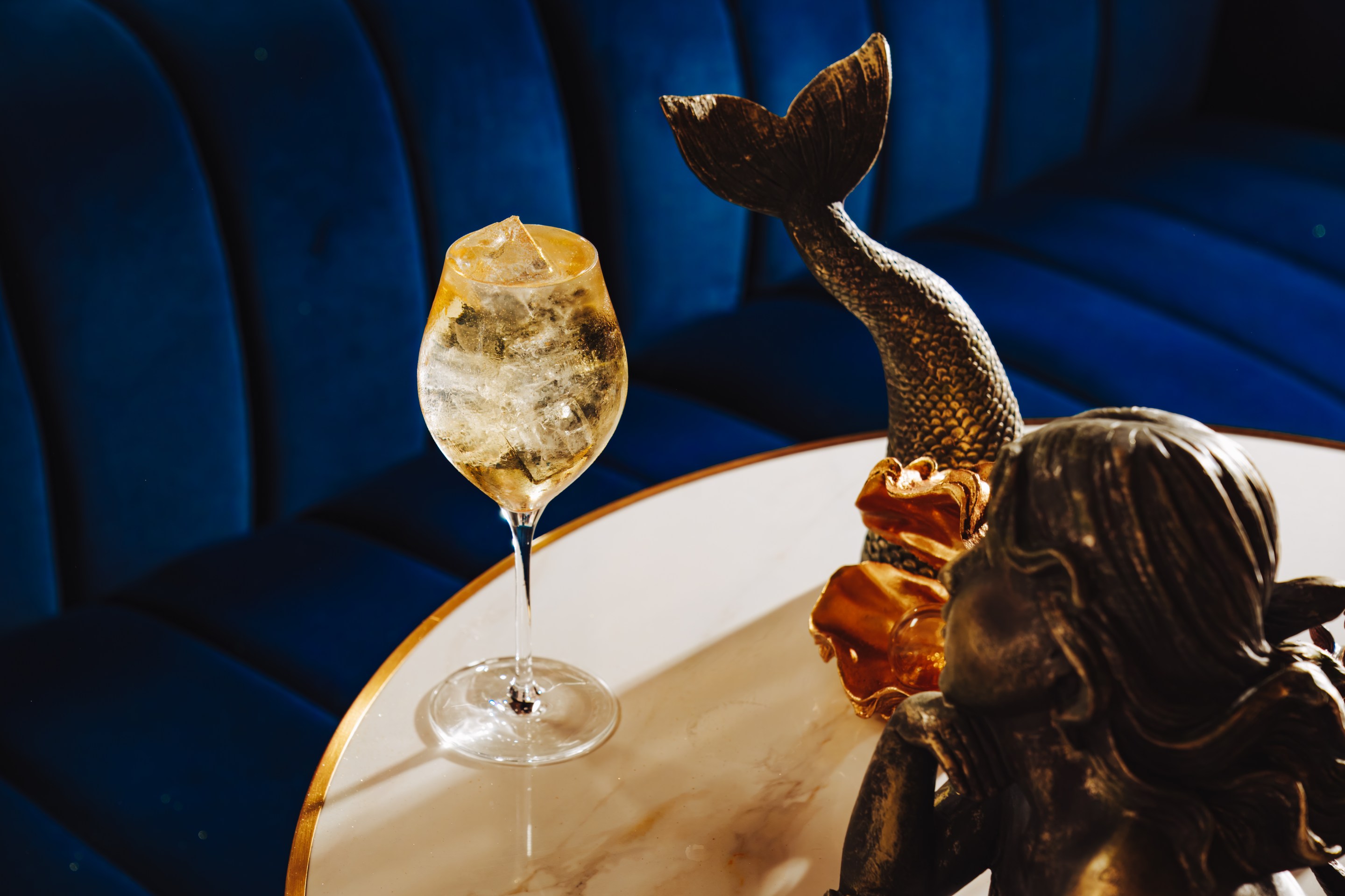 The Seirēn Song Spritz, a gold-infused cocktail inspired by the aperitif traditions of Portugal and Spain