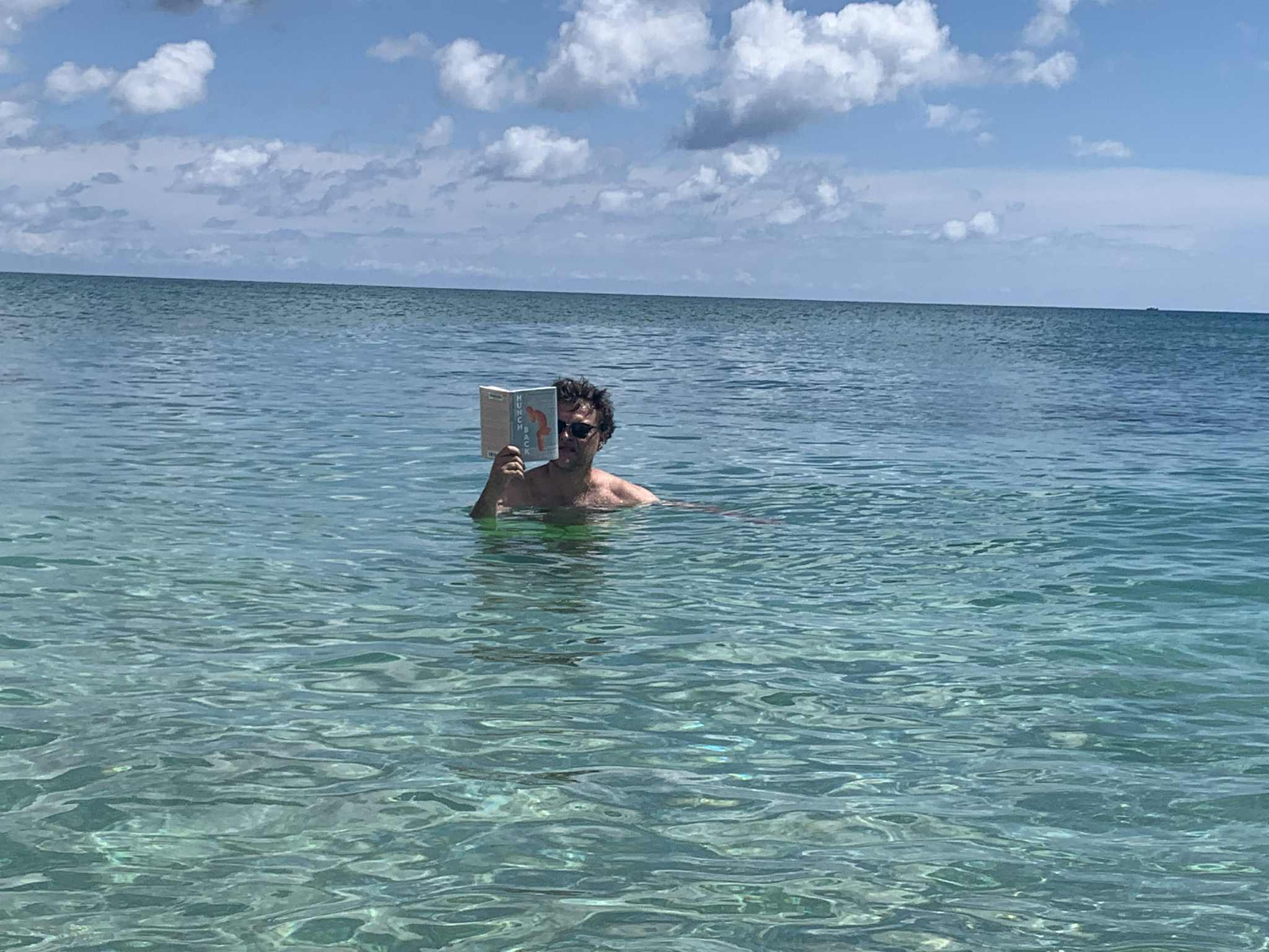 Author Emanuele Pettener reading off the coast in his adopted hometown of Boca Raton, FL.