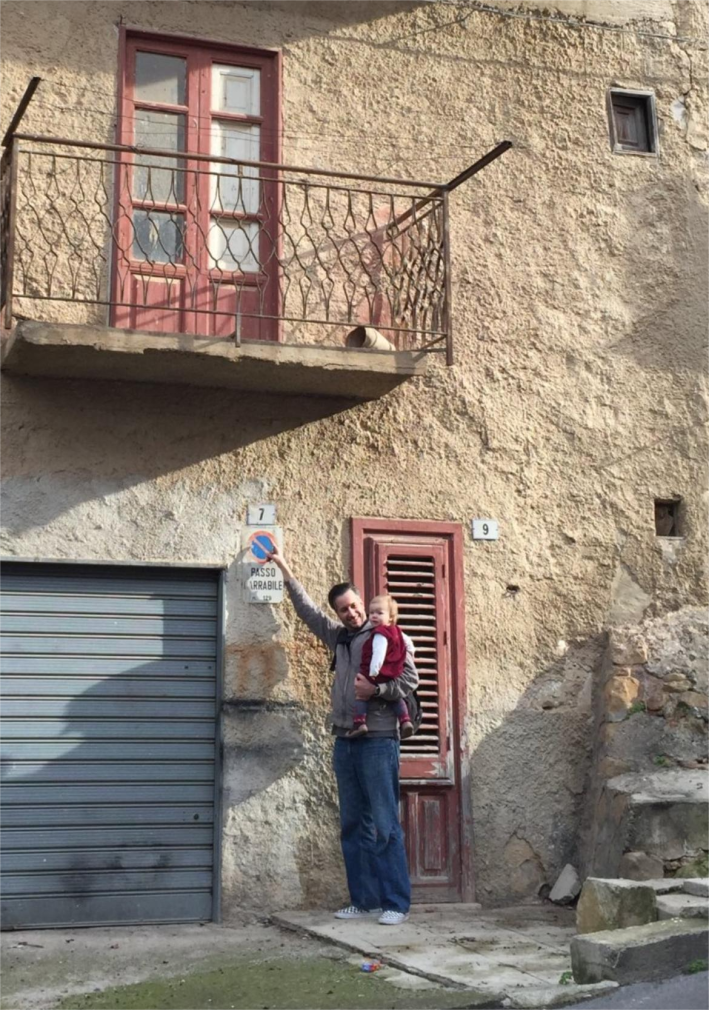 Jordan with his daughter outside of grandfather's home in Montemaggiore Belsito, Sicily (2014).