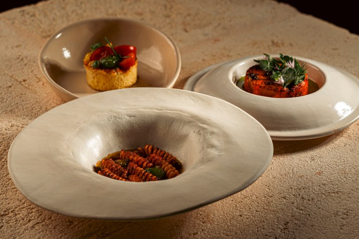 Three plated dishes featuring pasta and vegetables at Due Camini
