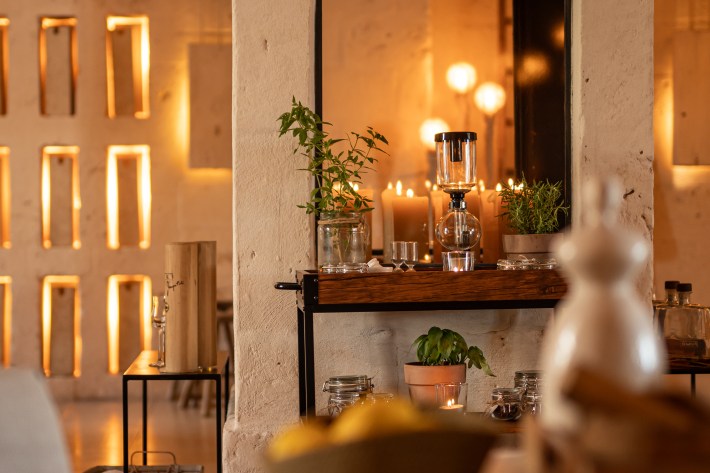 Warm interior dining space at Due Camini with candles and soft lighting