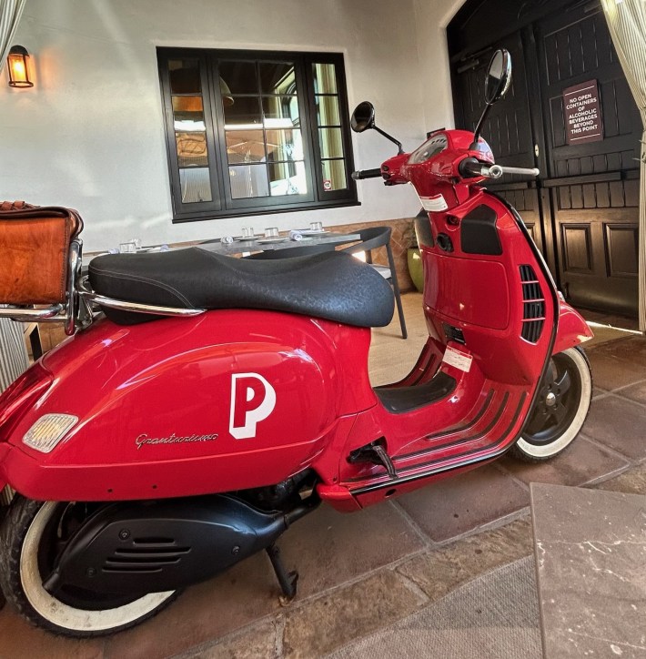 A red Vespa adds a playful Italian accent to the scene at Piatti in Laguna Beach.