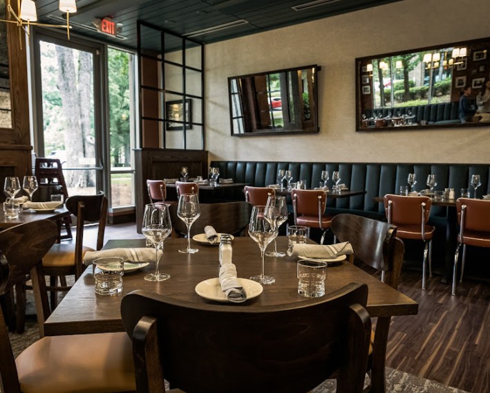 The dining room at Little Mama’s is warm, relaxed, and designed for long meals.