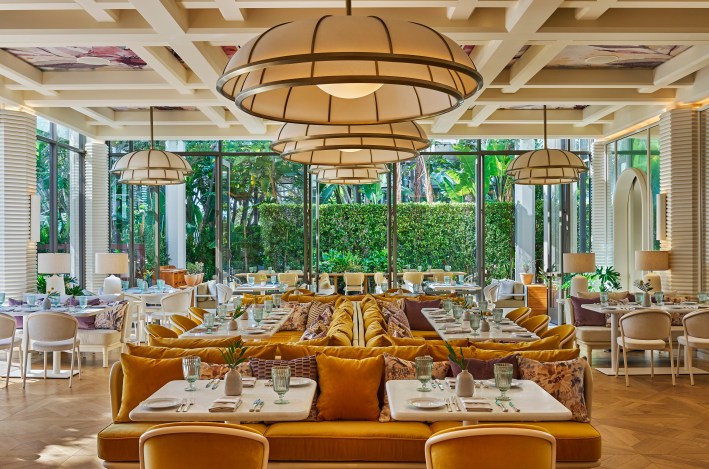 Elegant dining room at Viamara restaurant with warm lighting and garden views