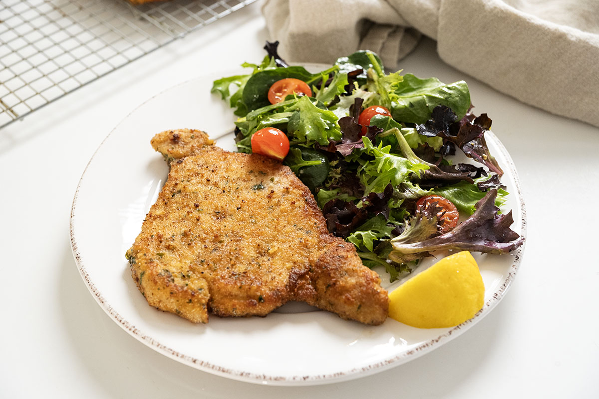 Vinny DelGiudice’s Pork Chop Milanese paired with a light spring salad.