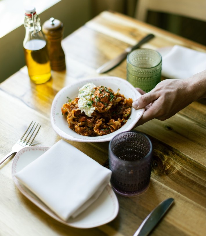 Italian pasta dish with ricotta and tomato sauce served on table