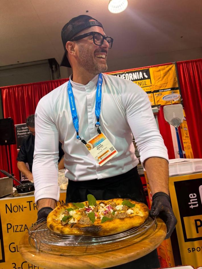 Boris Bérard of ORA-1929 with Cali Pasture, the pizza that earned him the Grand Champion title in the Non-Traditional category at the California Pizza Challenge in Anaheim.