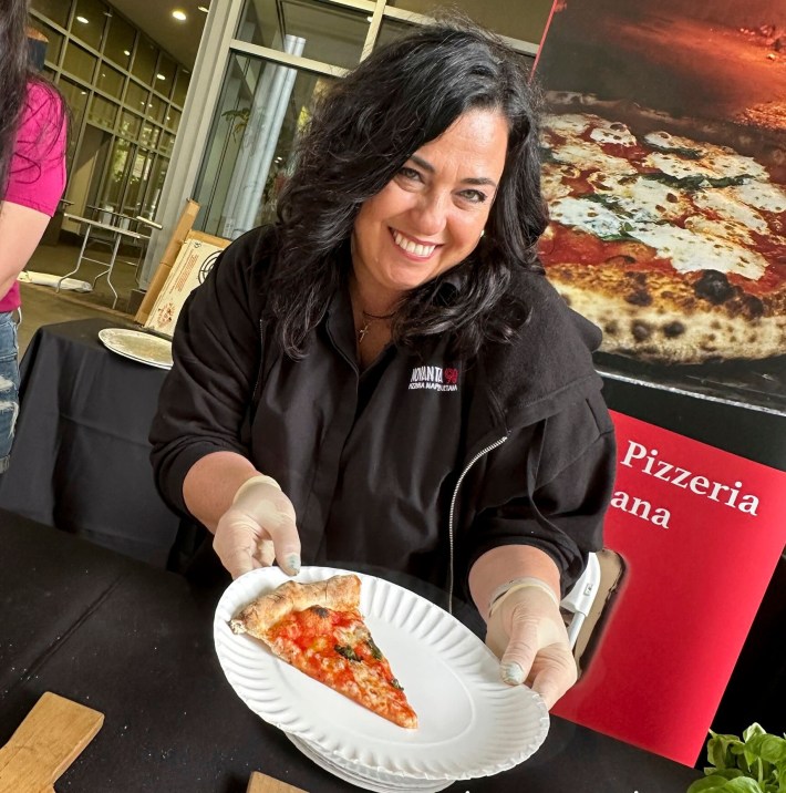 Fresh pizza is served throughout the event, highlighting simple, traditional Italian flavors.