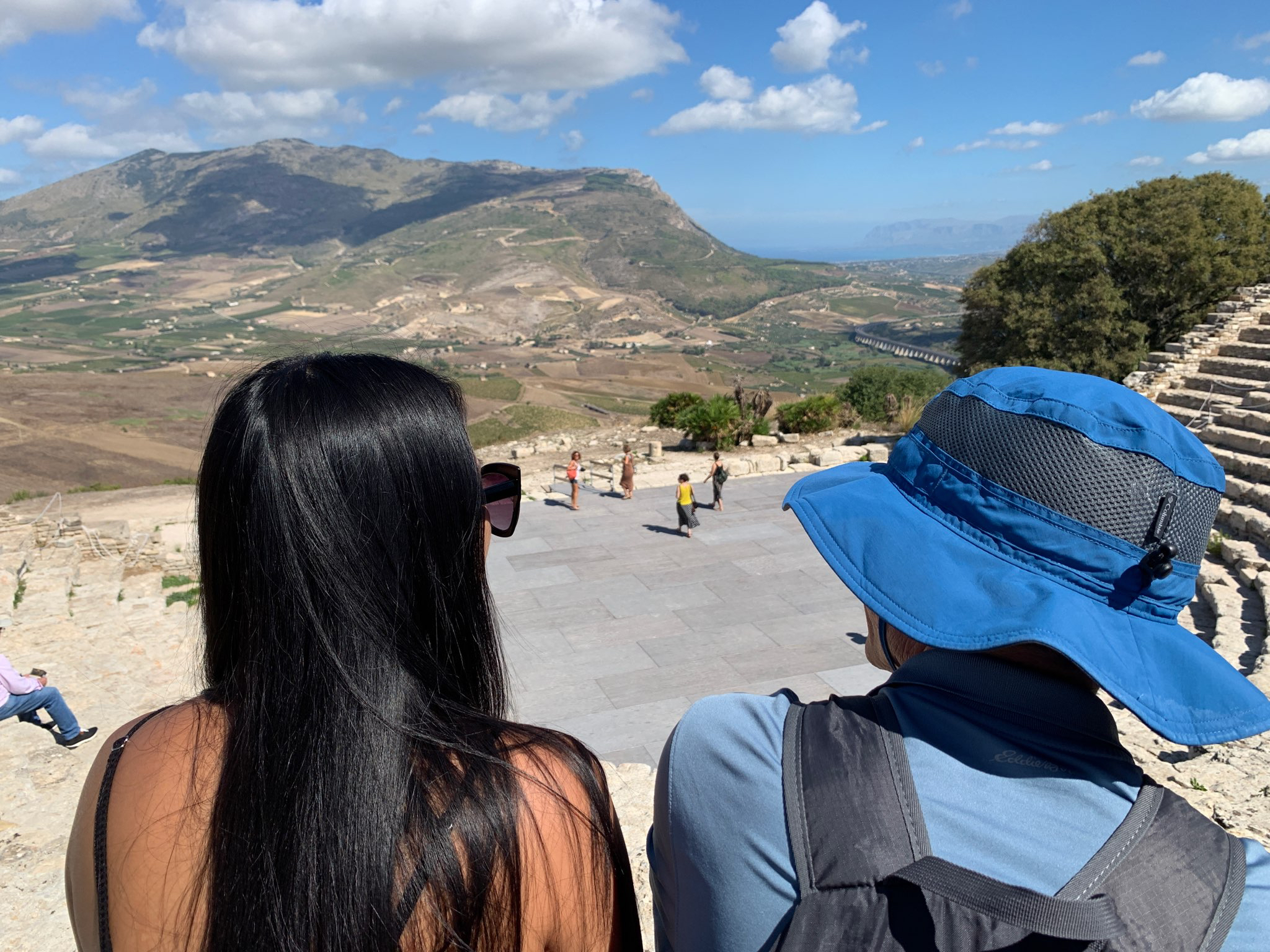 Two travelers enjoy the ancient Greek ruins of Segesta in Sicily,