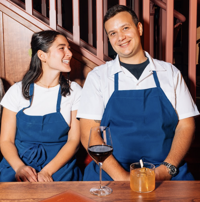 Chefs Manny and Gina Ocasio seated inside Mira restaurant in Buffalo.