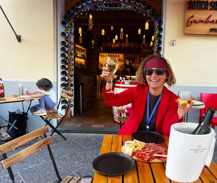 Food guide toasting with wine in Sorrento.
