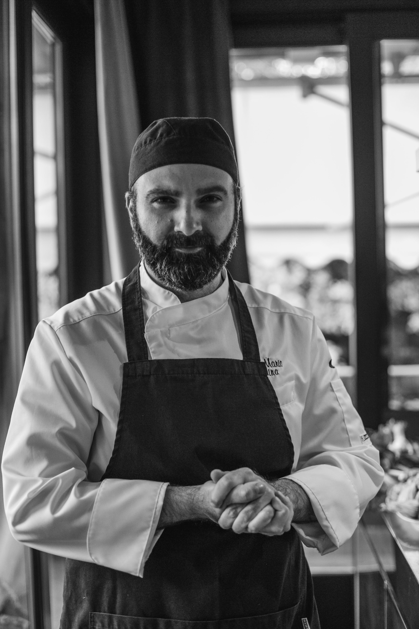 Chef Mario Traina in the kitchen with an apron on.