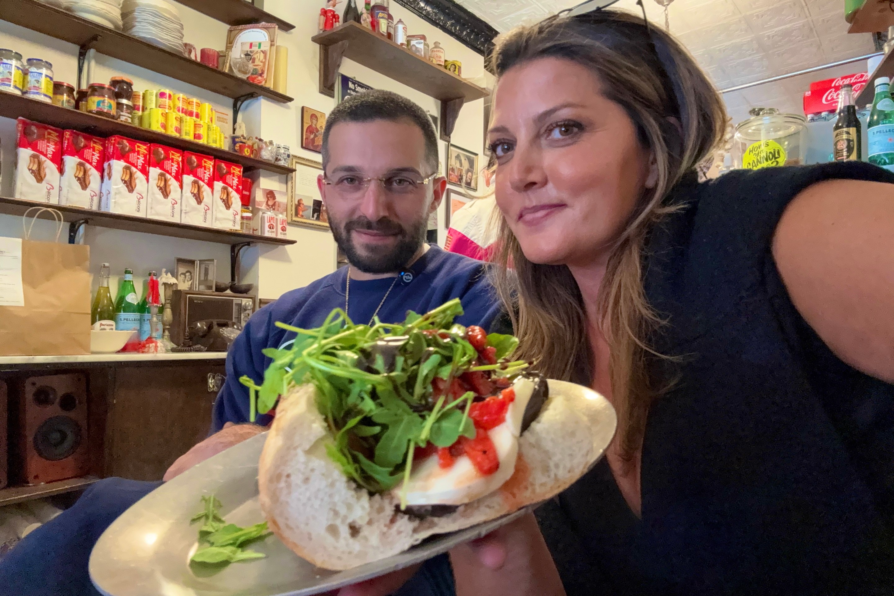 Regina’s Grocery eggplant sandwich inside the Orchard Street location with Roman Grandinetti and Joanna Moehler