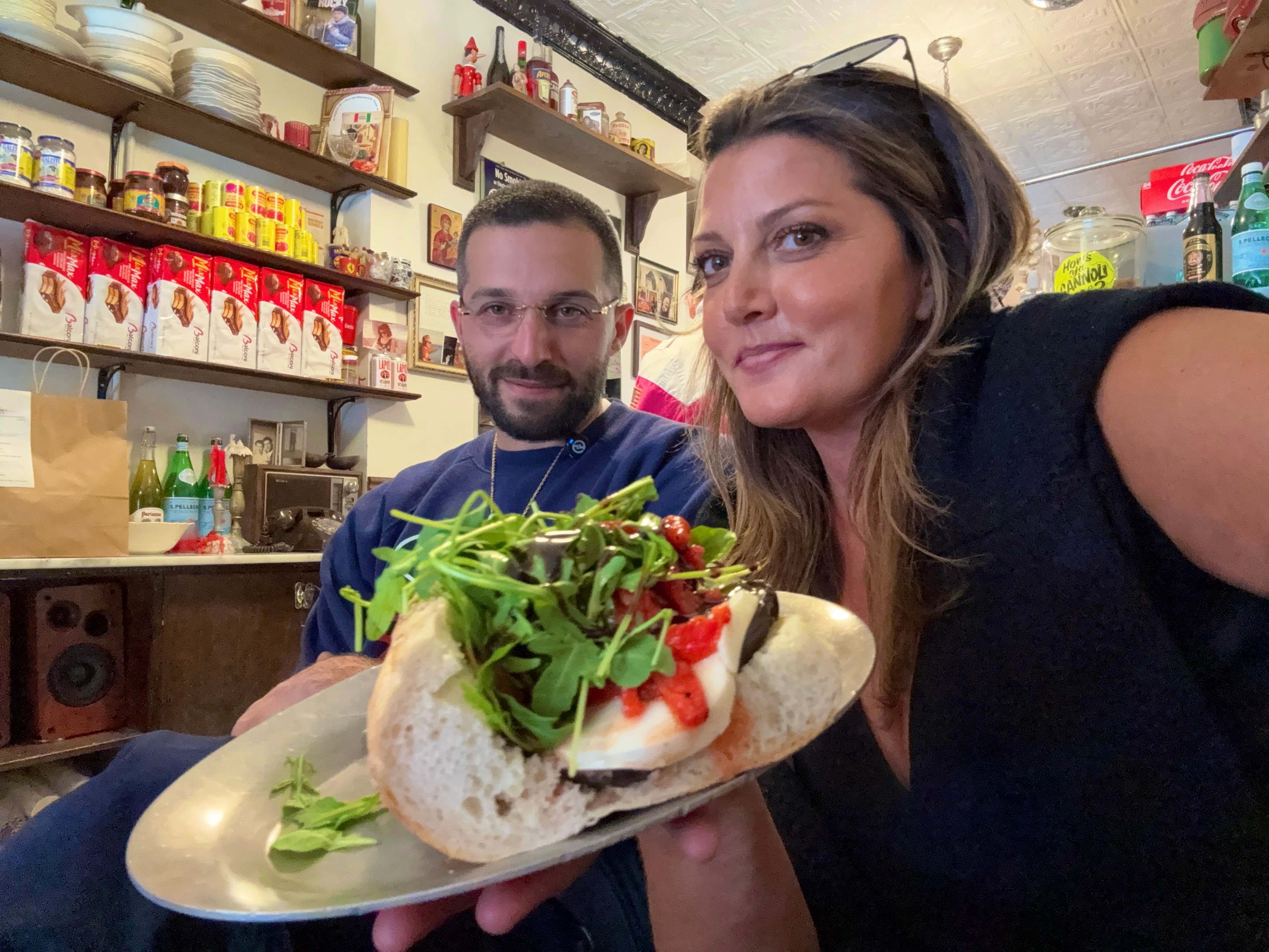 Regina’s Grocery eggplant sandwich inside the Orchard Street location with Roman Grandinetti and Joanna Moehler