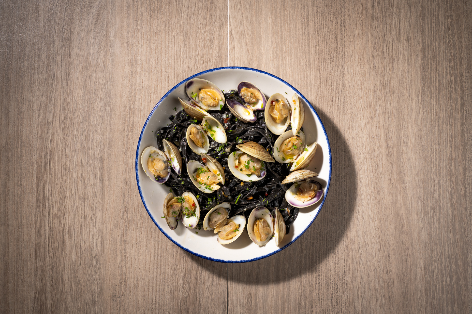 Squid ink linguine vongole with littleneck clams, garlic, and parsley.