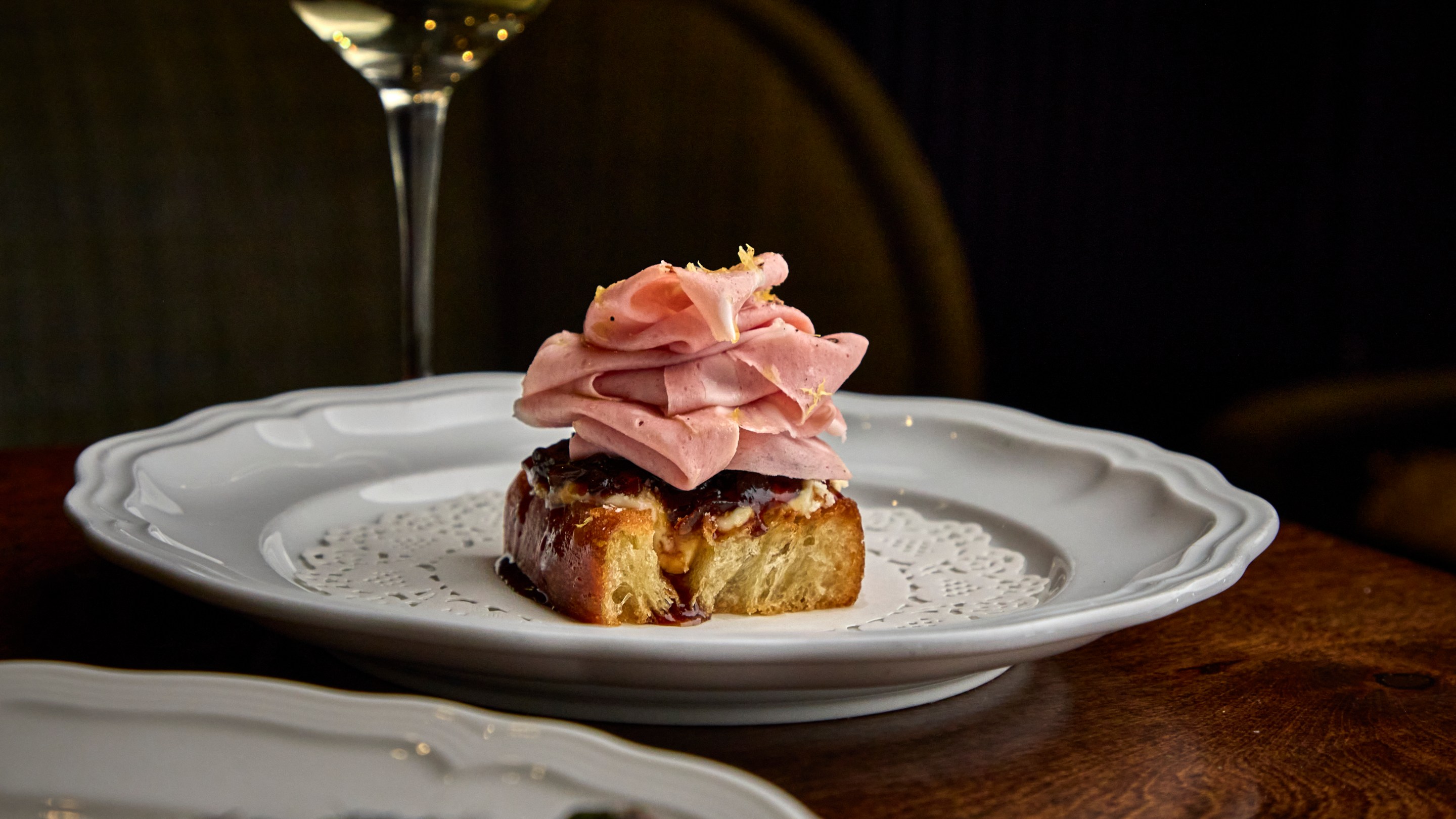 Mortadella toast appetizer topped with sliced mortadella at Alla Vita Nashville